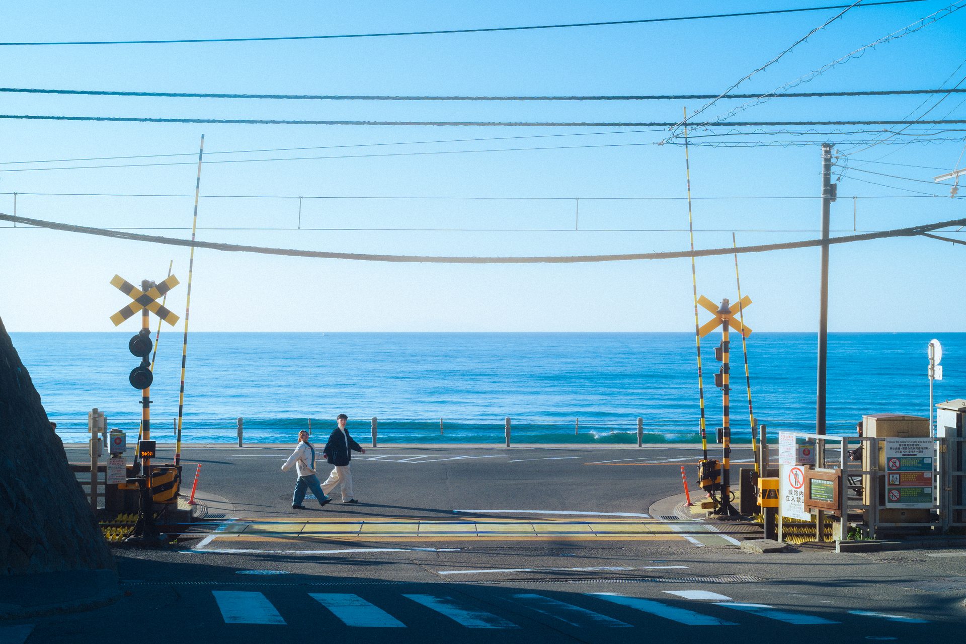 A railway crossing by the sea in Kamakura