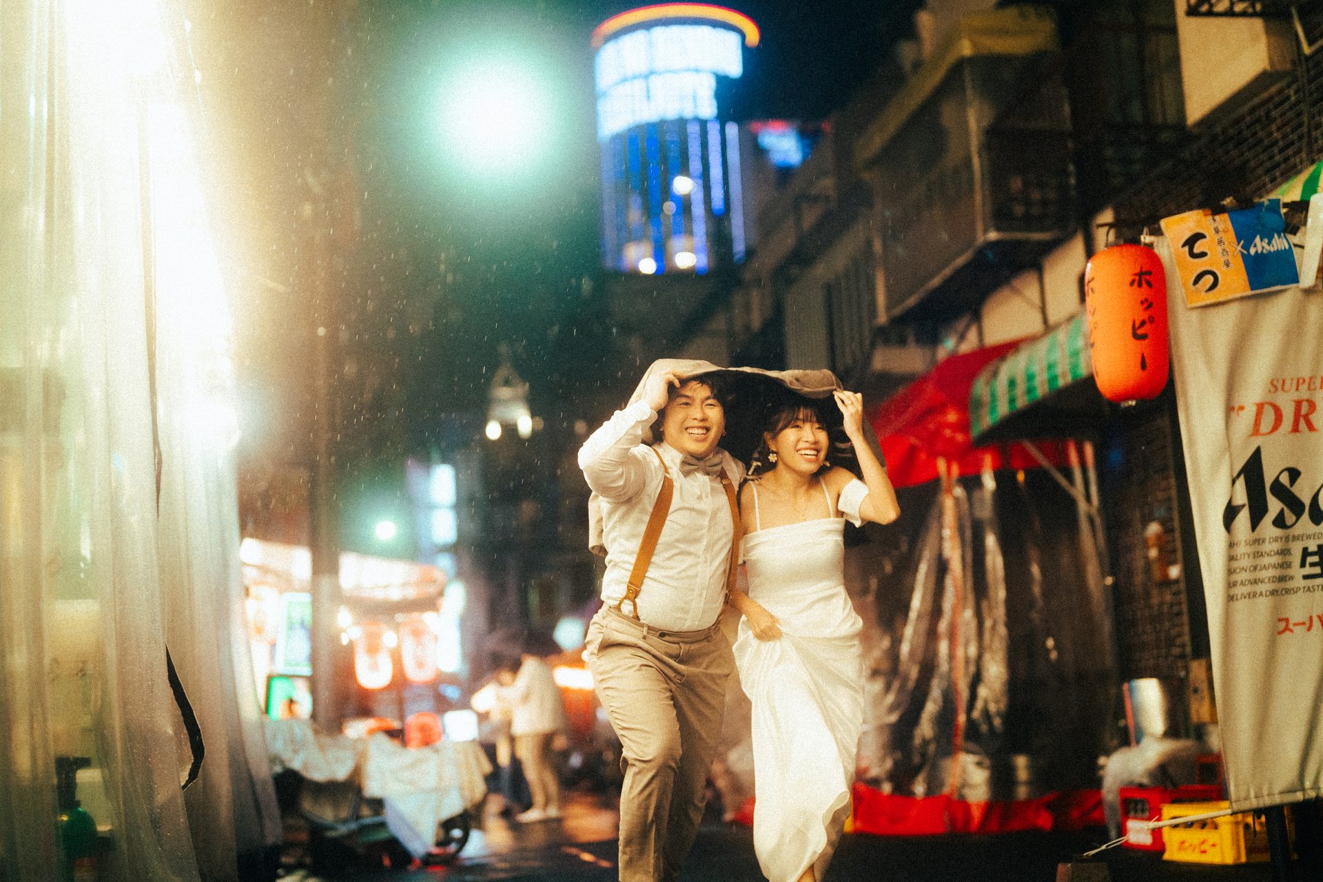 Laughing down a lantern-lit street at night