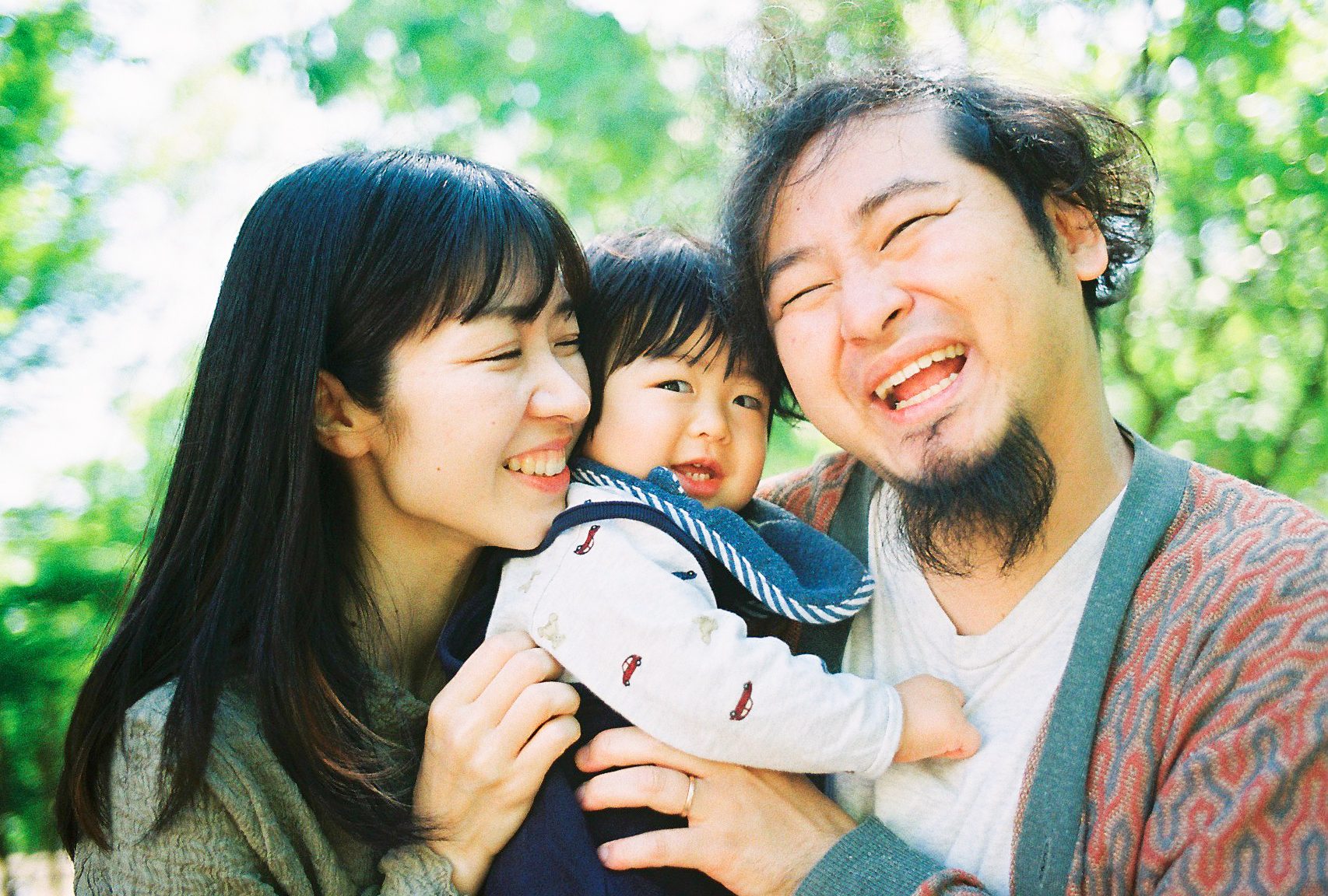 A family laughing cheek to cheek