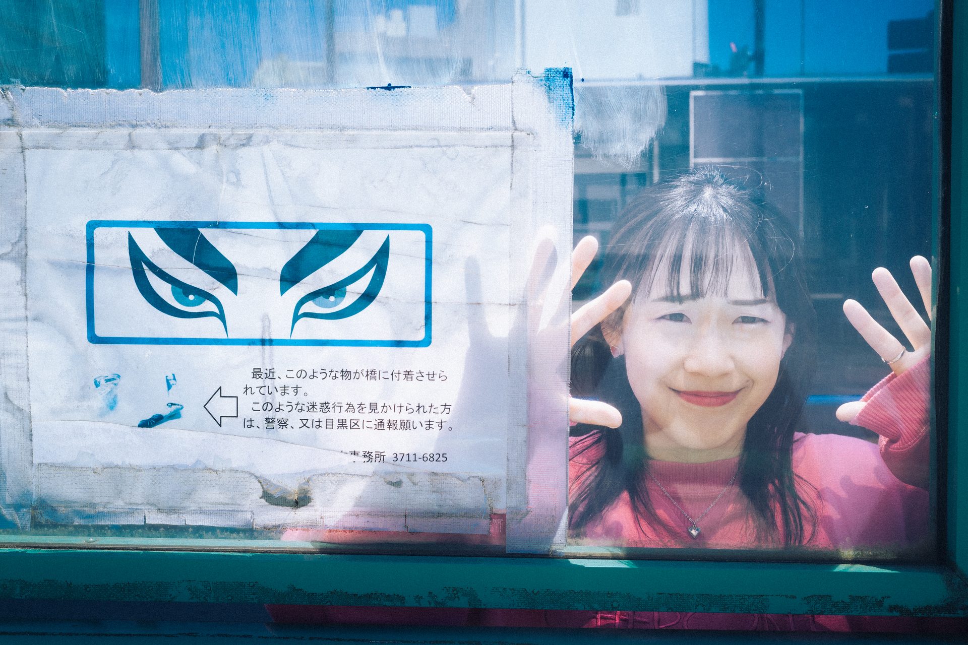 Hands on the glass, laughing